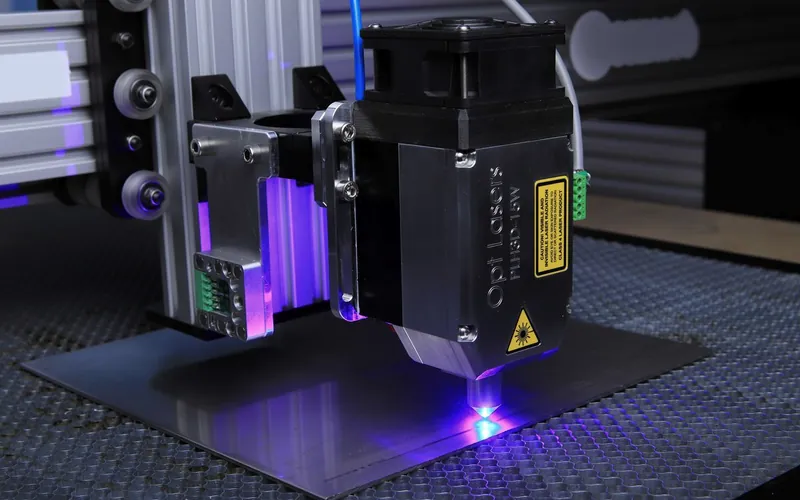 A laser head engraving a metal surface